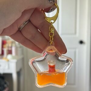 Star-Shaped Keychain With Smiling Cup Inside